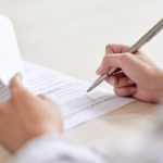 Person carefully reviewing and signing a storage facility contract in South Africa highlighting the importance of reading terms before committing