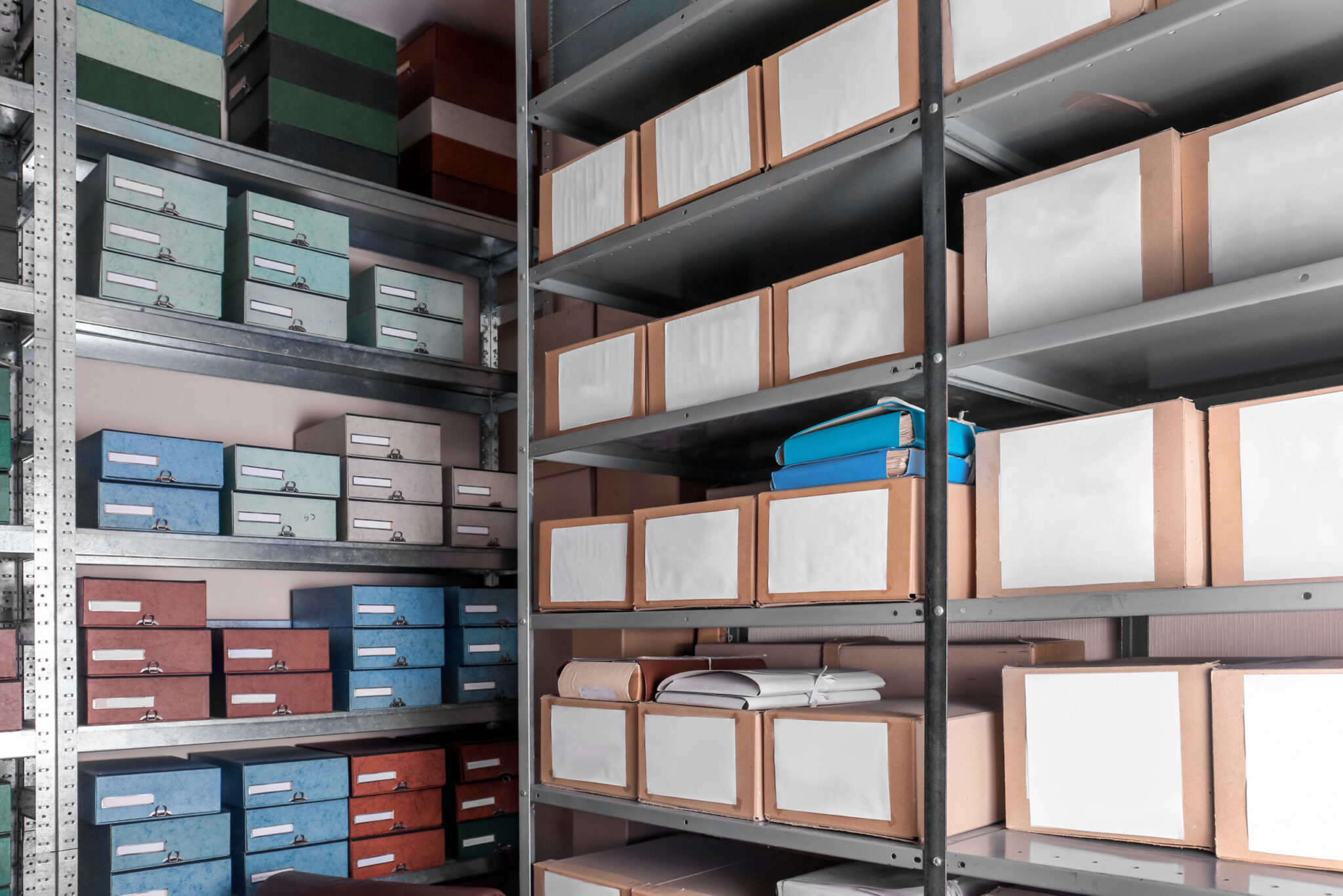 Metal archive shelves stacked with labelled coloured and cardboard document boxes in a secure physical document storage facility in Johannesburg