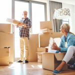 Couple packing moving boxes together in a modern Johannesburg home or office before transferring items to a Midrand storage facility
