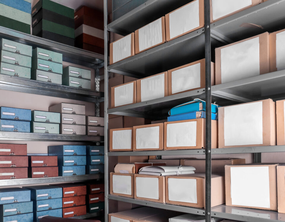 Metal archive shelves stacked with labelled coloured and cardboard document boxes in a secure physical document storage facility in Johannesburg